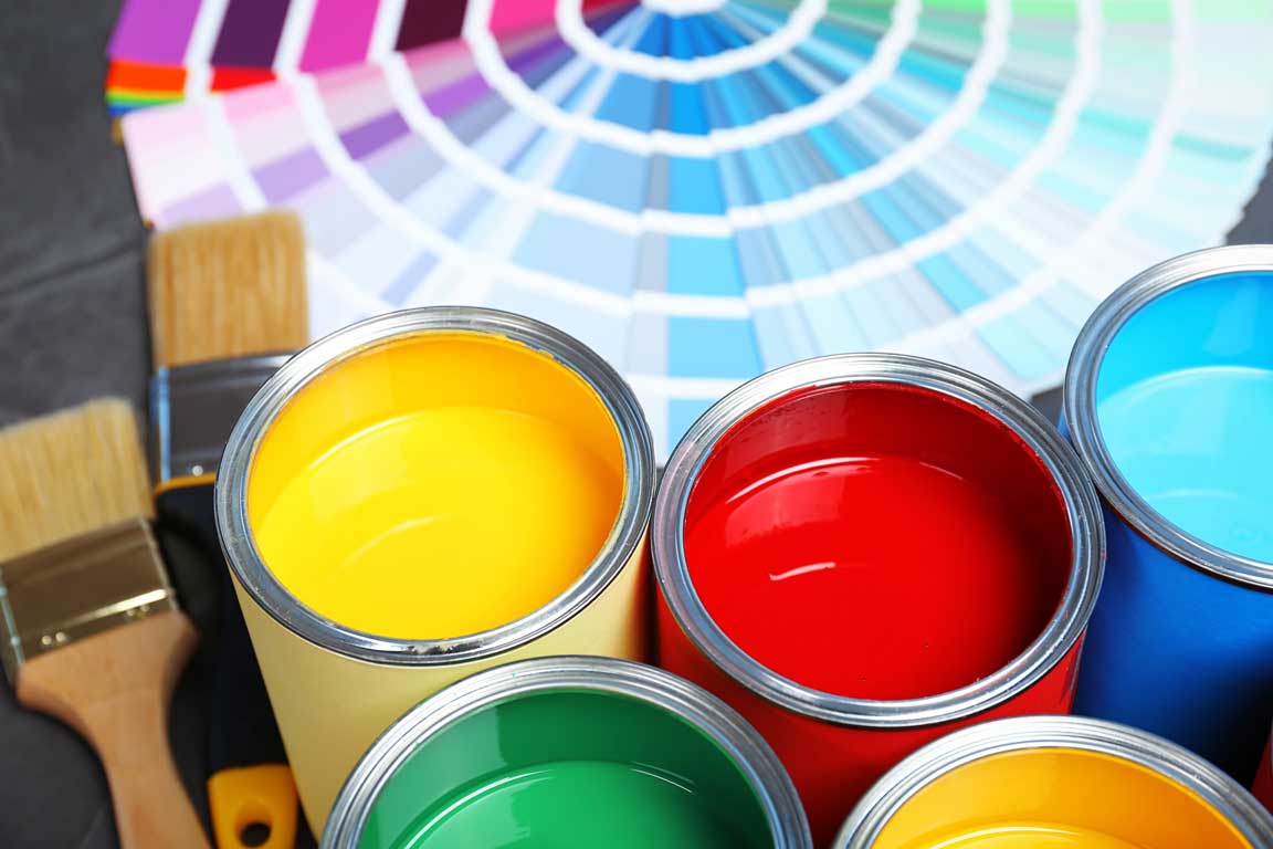 Paint Cans And Color Palette Samples On Table, Closeup